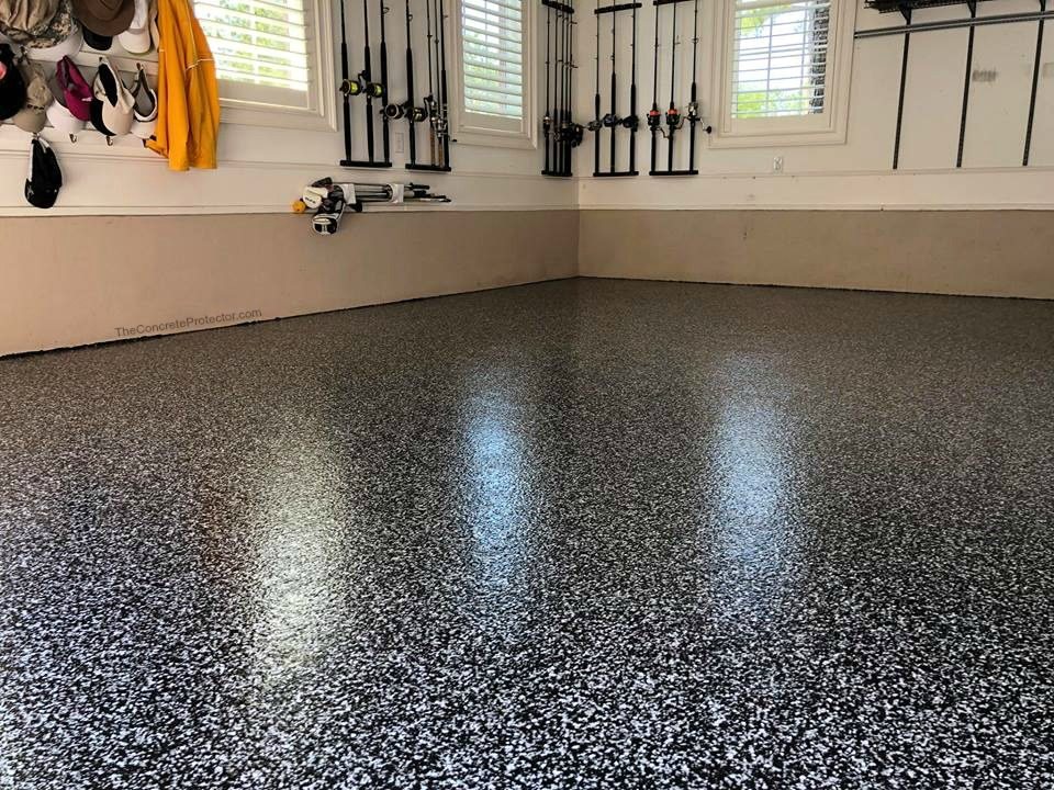 Glossy gray flake epoxy floor in a finished two-car garage