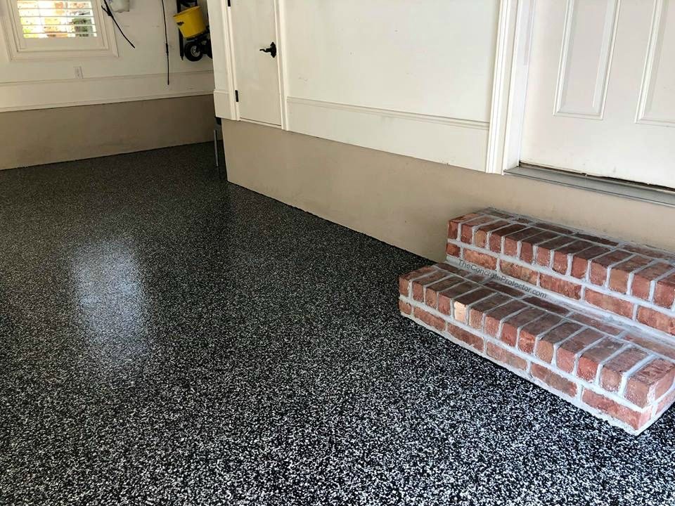 Flake epoxy garage floor with brick steps leading into the house