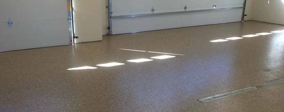 Brown flake epoxy floor in a clean three-car garage